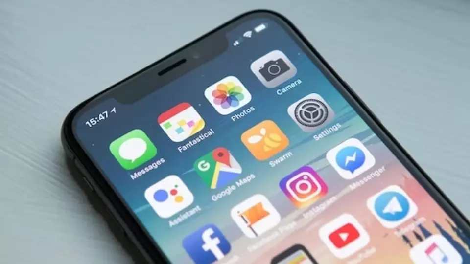 An iPhone with apps displayed on screen; Uncover iOS 17 Hidden Features to Master This New OS